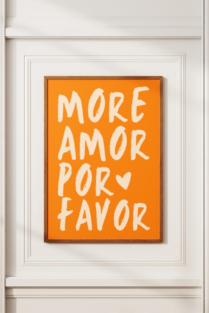 Typography picture in a frame. "More Amor Po Favor" in Orange