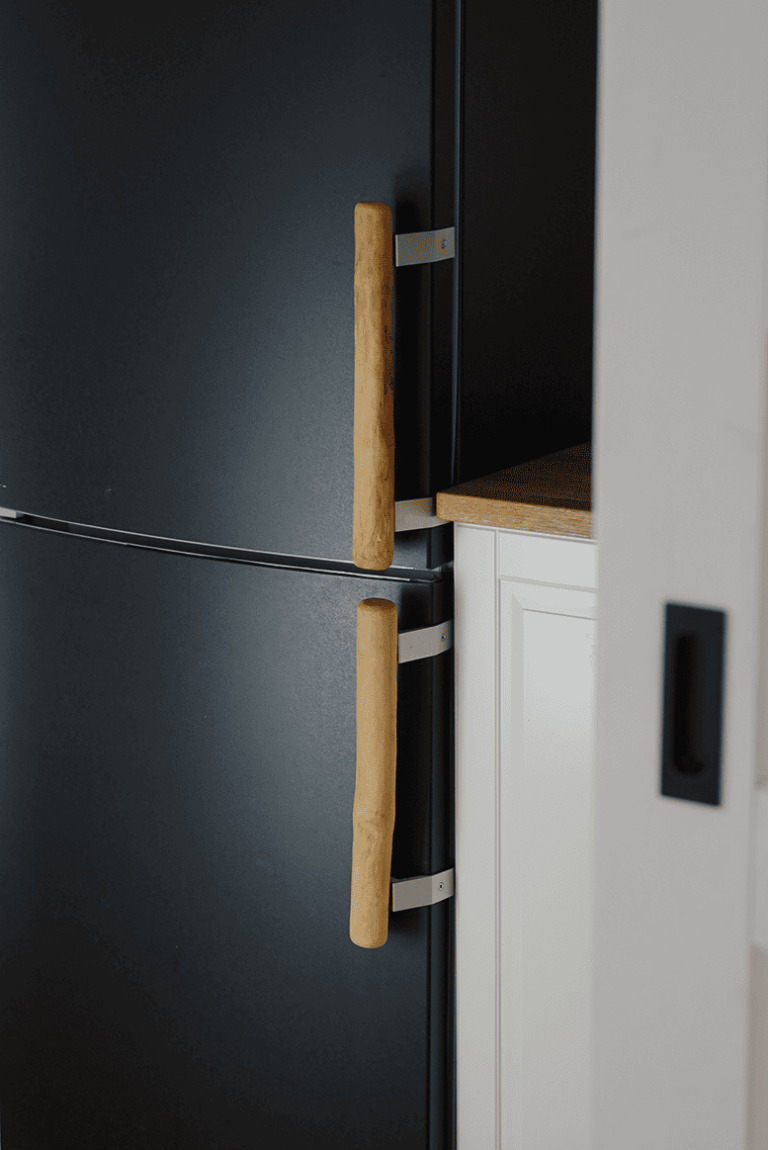 Black fridge with two self-made wooden handles